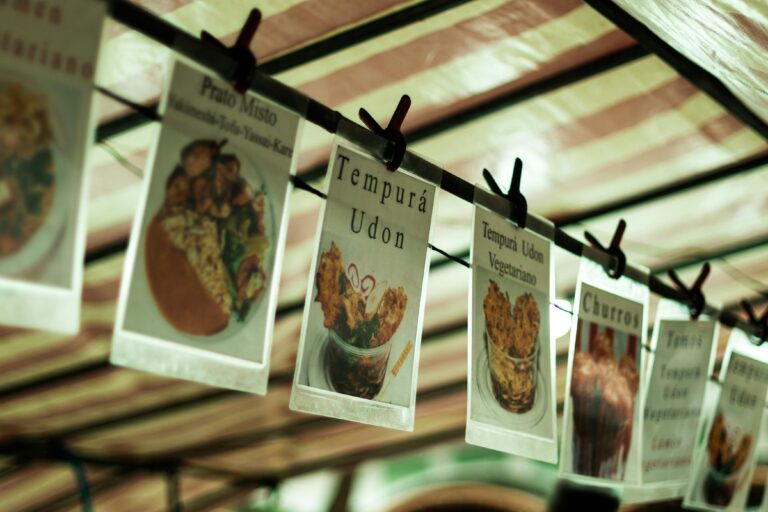 Close-up of various food menu cards hanging at a food market in São Paulo, Brazil.